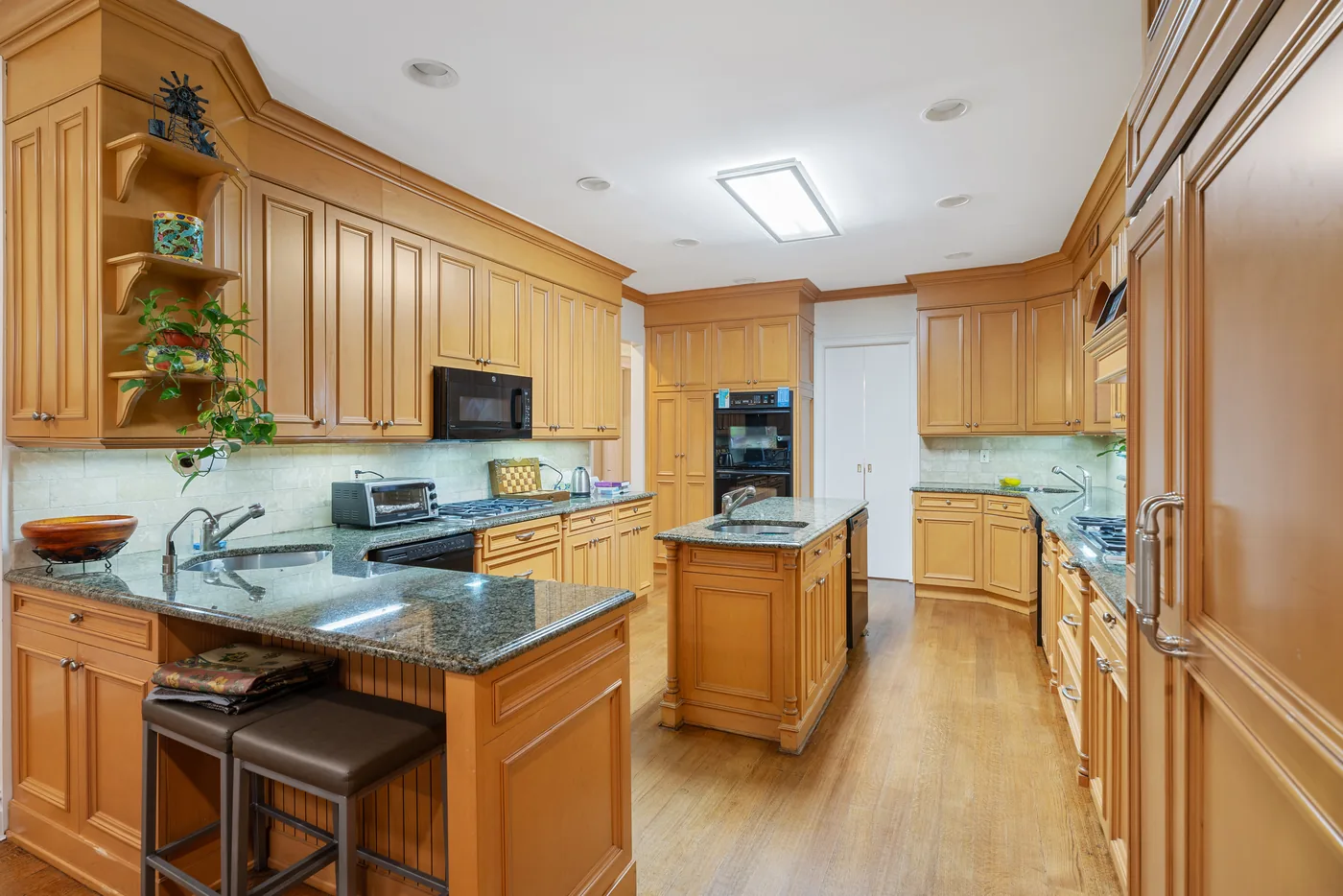 Wood kitchen with breakfast bar photographed for a New York City real estate listing.